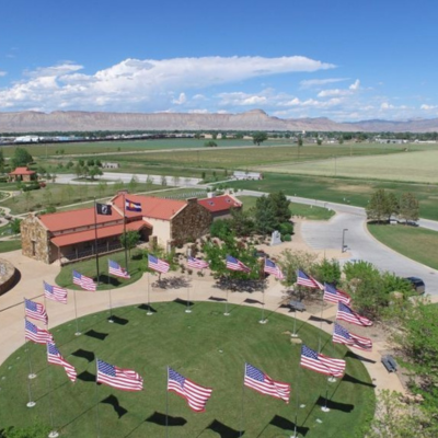 Drone view of the Veterans Memorial Cemetery featuring the circular lawn with US flags. 